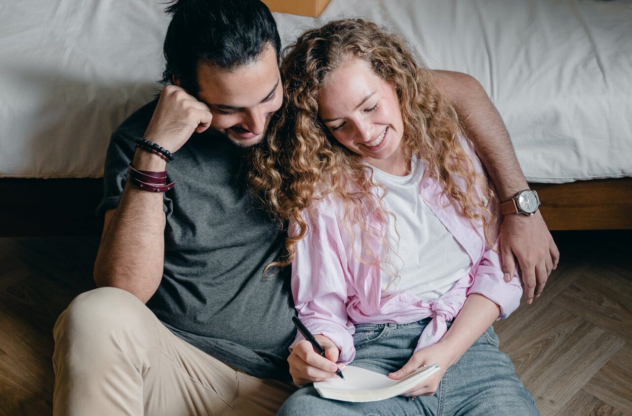 happy couple making a moving checklist before moving from Idaho Falls to Las Vegas