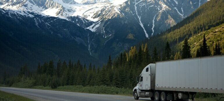 A white truck near mountains representing the cross country moving companies Sacramento offers.