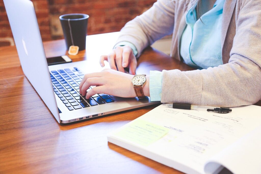 A woman looking at her laptop