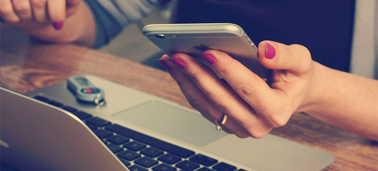 A woman using a mobile phone in her office