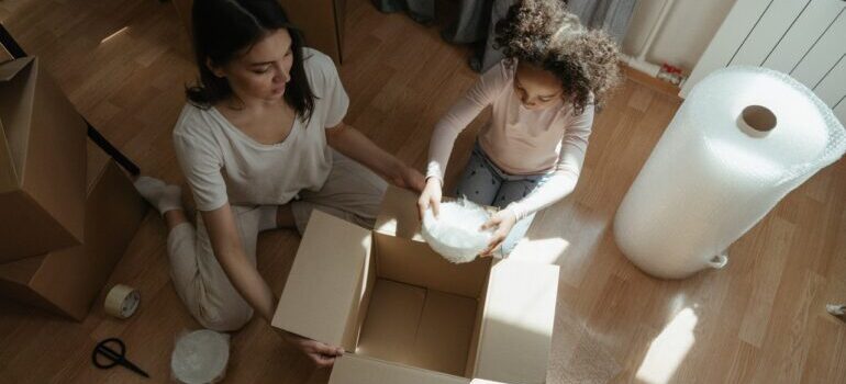 mother and daughter packing before moving from Kansas to Colorado