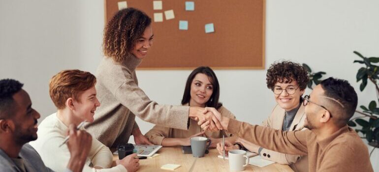team on a meeting and two people shaking hands