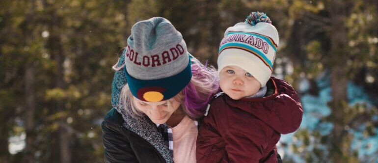 A mom walking up a mountaintop with her daughter. 