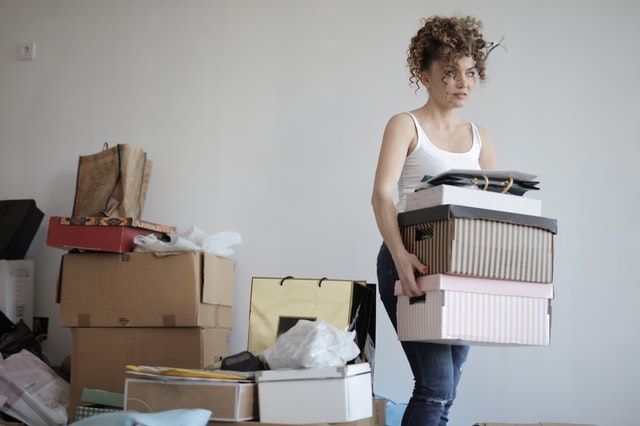 A woman de-cluttering her apartment