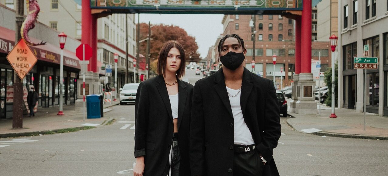 A fashionable multicultural couple on the street.