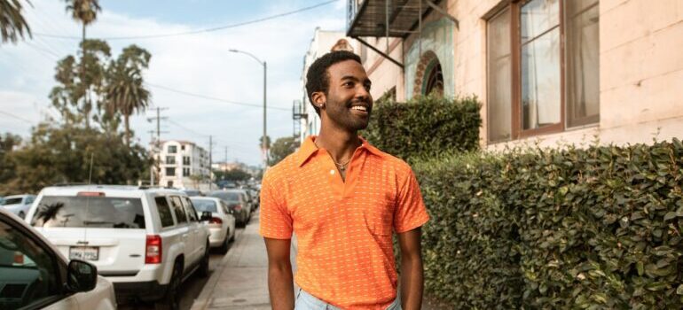 Man in orange shirt walking