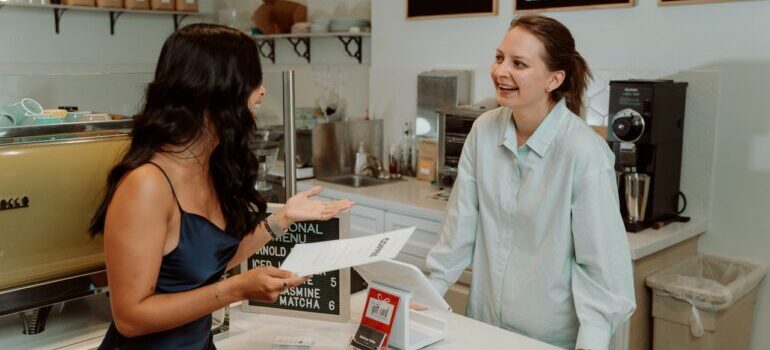 A cashier and customer chatting