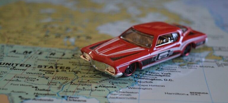 A red model car on a map.