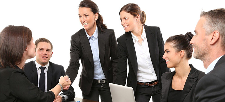 People in suits, on a meeting, shaking hands