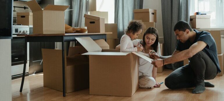 A family packing for a move before hiring cross country movers Kent