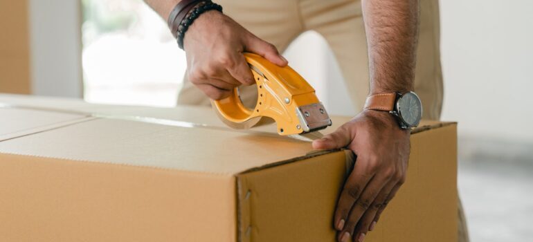 man packing a moving box