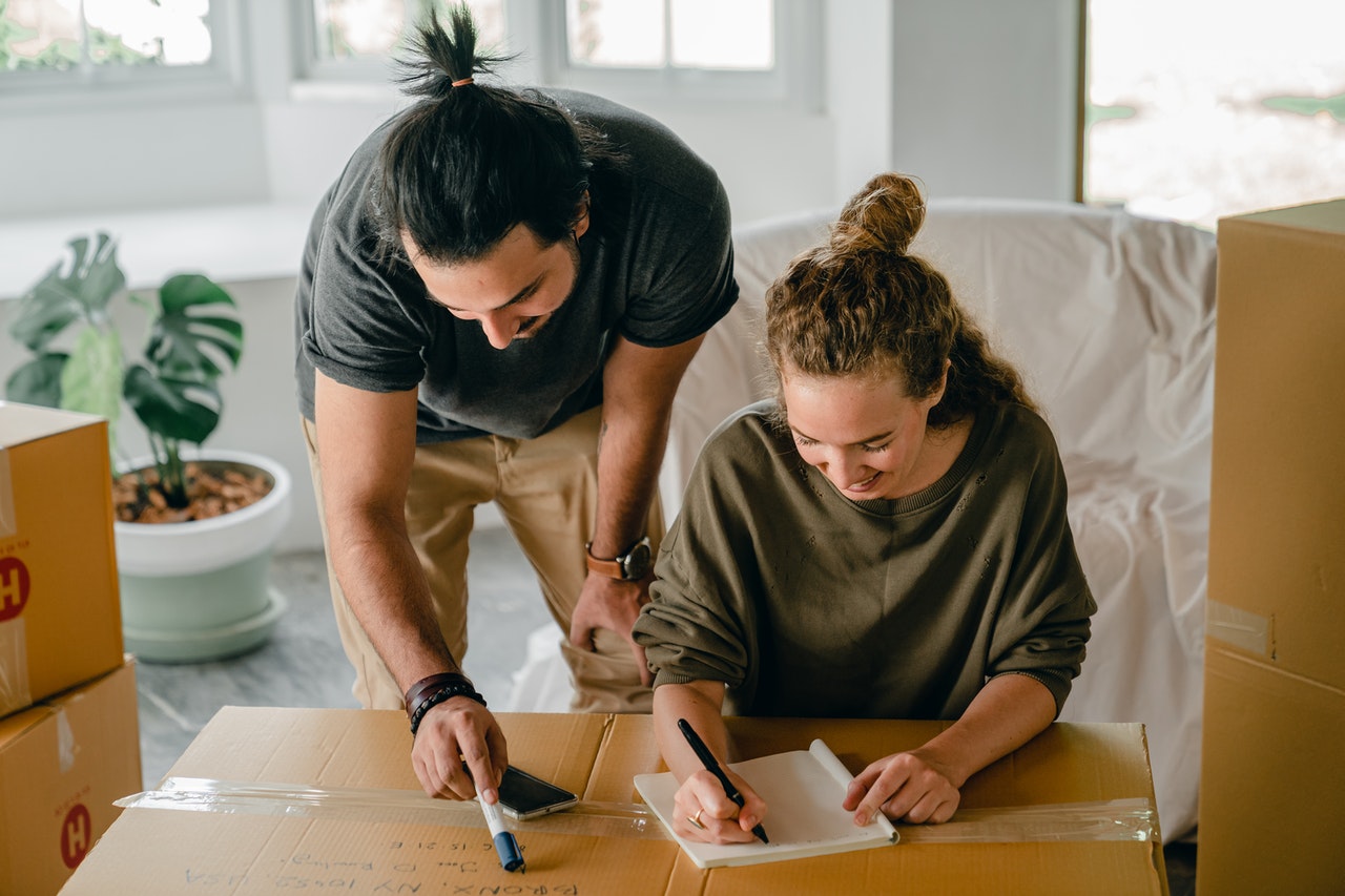 A couple writing a moving checklist for moving from Texas to Washington State