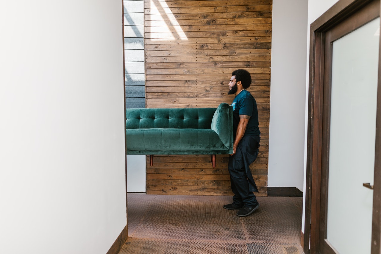 A mover carrying a couch