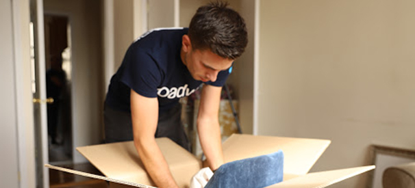 roadway moving crew member packing a box