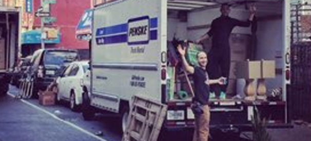 solidarity movers waving from a truck