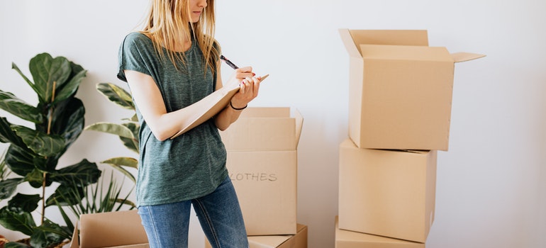 Woman writing while packing