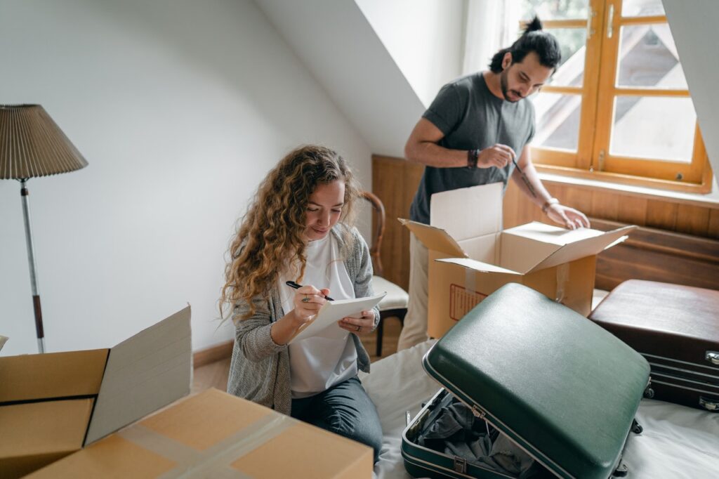 a couple packing their bedroom together before moving from Los Angeles to Austin TX