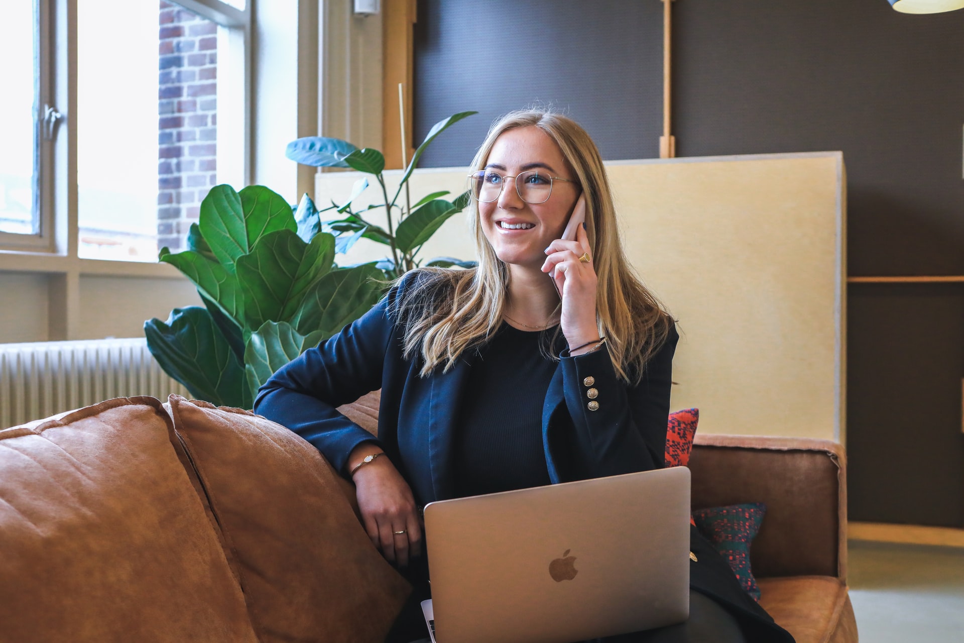 A woman on the phone, getting in touch with Excalibur Movers