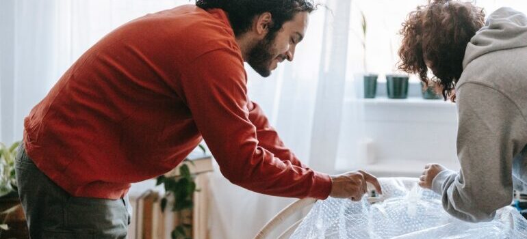 man and woman packing before moving to Georgia