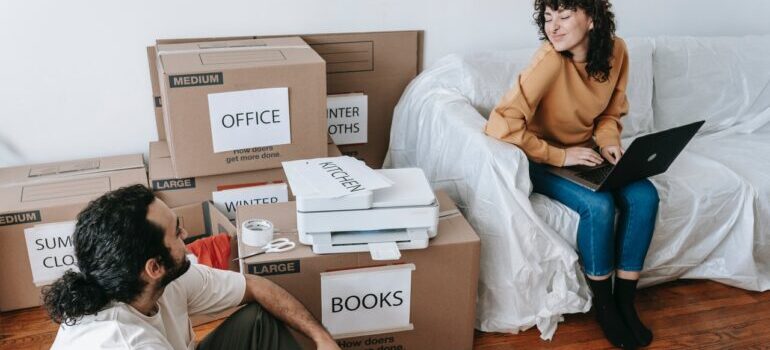 couple doing research on moving from Louisiana to Oklahoma while packing