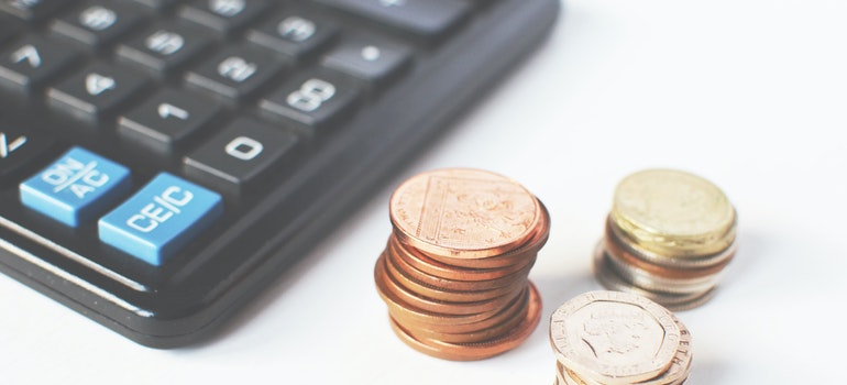 Calculator with some pennies around it