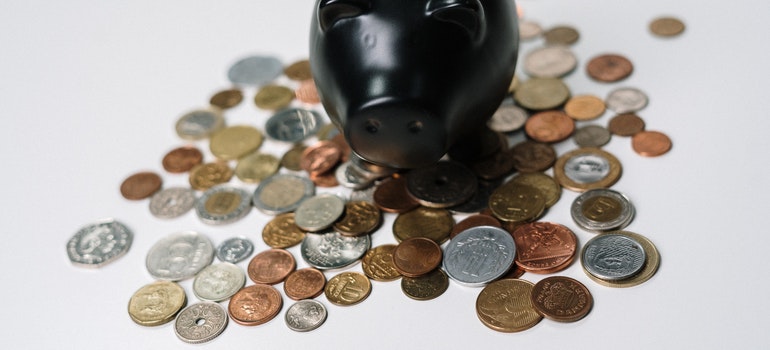 Piggy bank and pennies on white desk