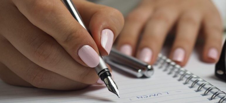 female writing, creating a list