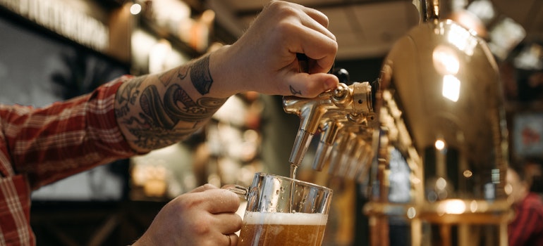 Man pouring beer in beer glass