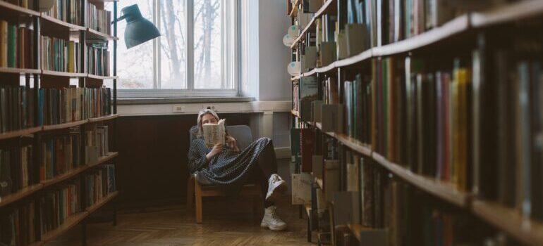woman reading a book in a library