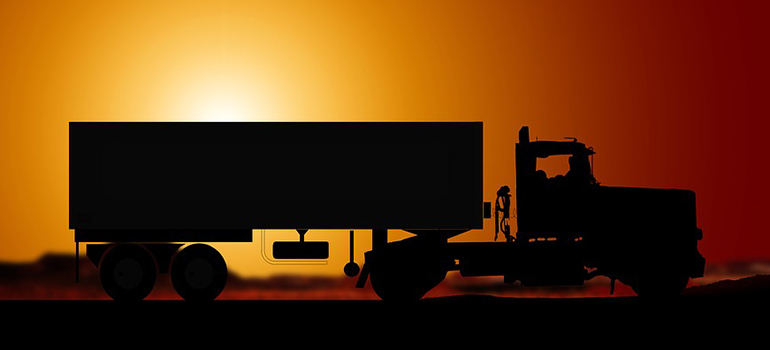 a silhouette of a moving truck 