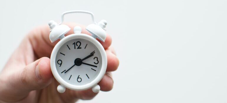 a hand holding a clock