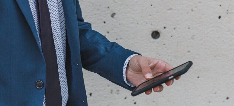 A man in a suit holding a phone.