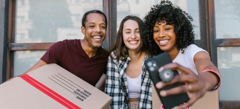 three people smiling for a selfie