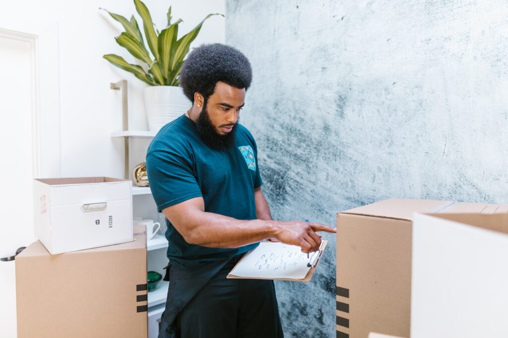 A mover checking up on a box, representing top movers in Miami