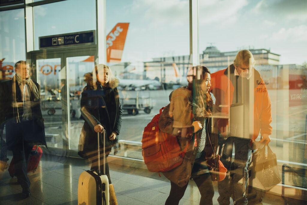 People on an airport carrying their bags