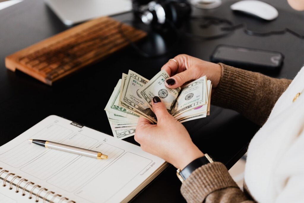 A woman counting money, and making plans