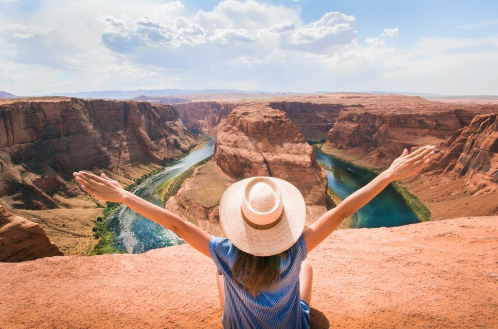 A girl spreading her arms in front of an Arizona nature scenery