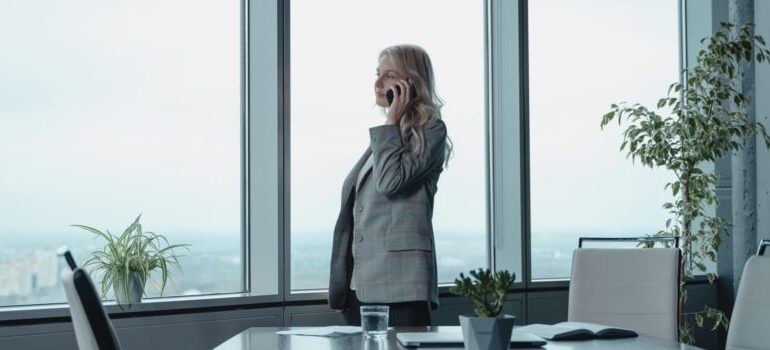 woman in an office, using a phone
