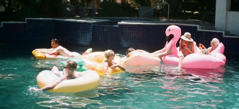 people in a pool, enjoying themselves