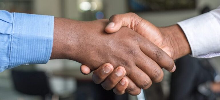 two people shaking hands with one another