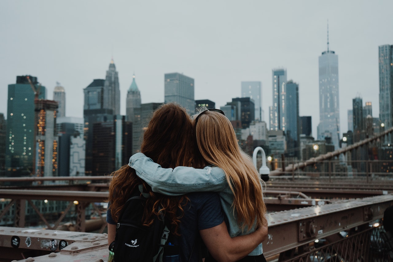 Two friends hugging in NYC.