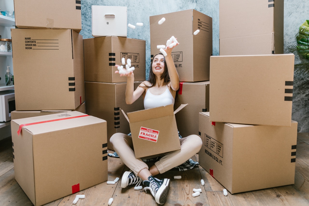 person sitting among cardboard boxes