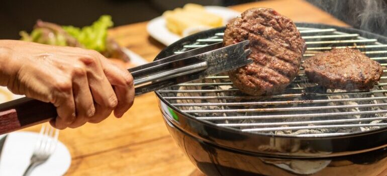 A person grilling meat.