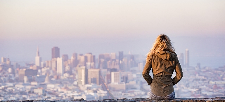  woman looking at San Francisco and thinking about changes in the relocation trends
