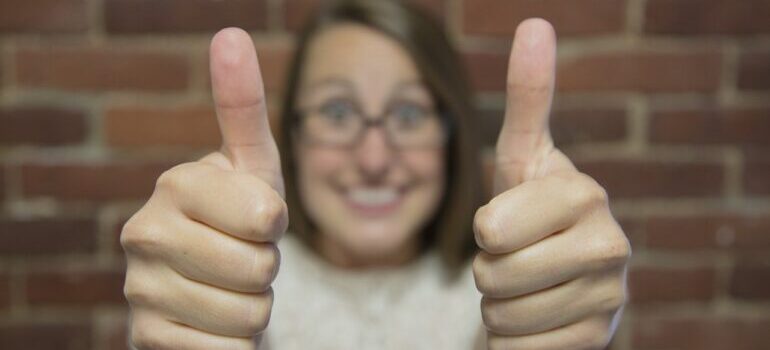 A girl giving a thumbs up gesture.