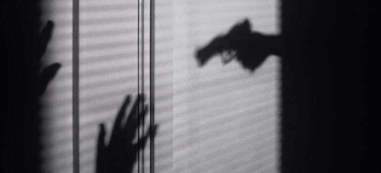 shadows depicting a gun pointed at a person