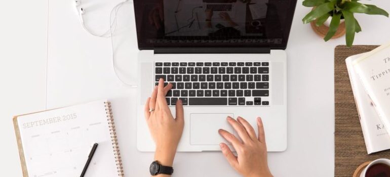 person using a laptop to research moving from Minneapolis to Atlanta