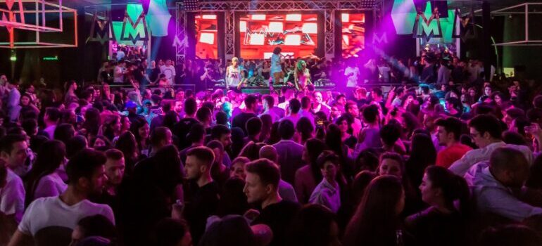 A crowded nightclub with neon lights