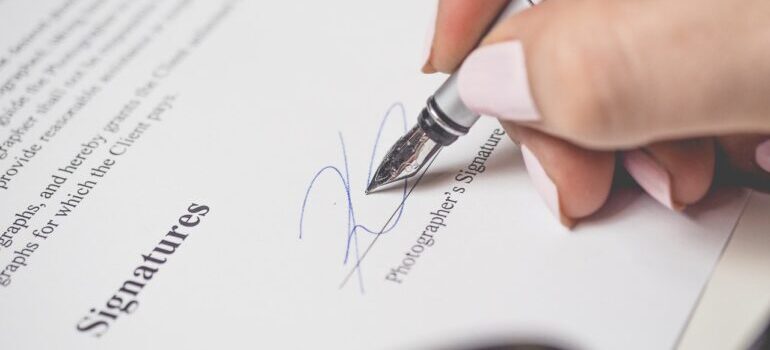 A woman signing a contract.