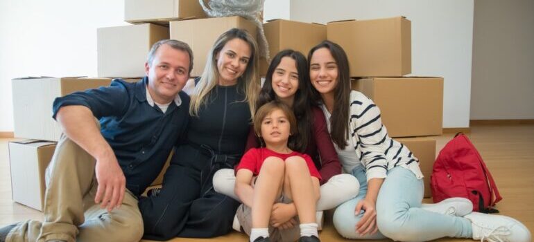 A happy family in front of moving boxes, after a successful relocation with long distance movers North Las Vegas.
